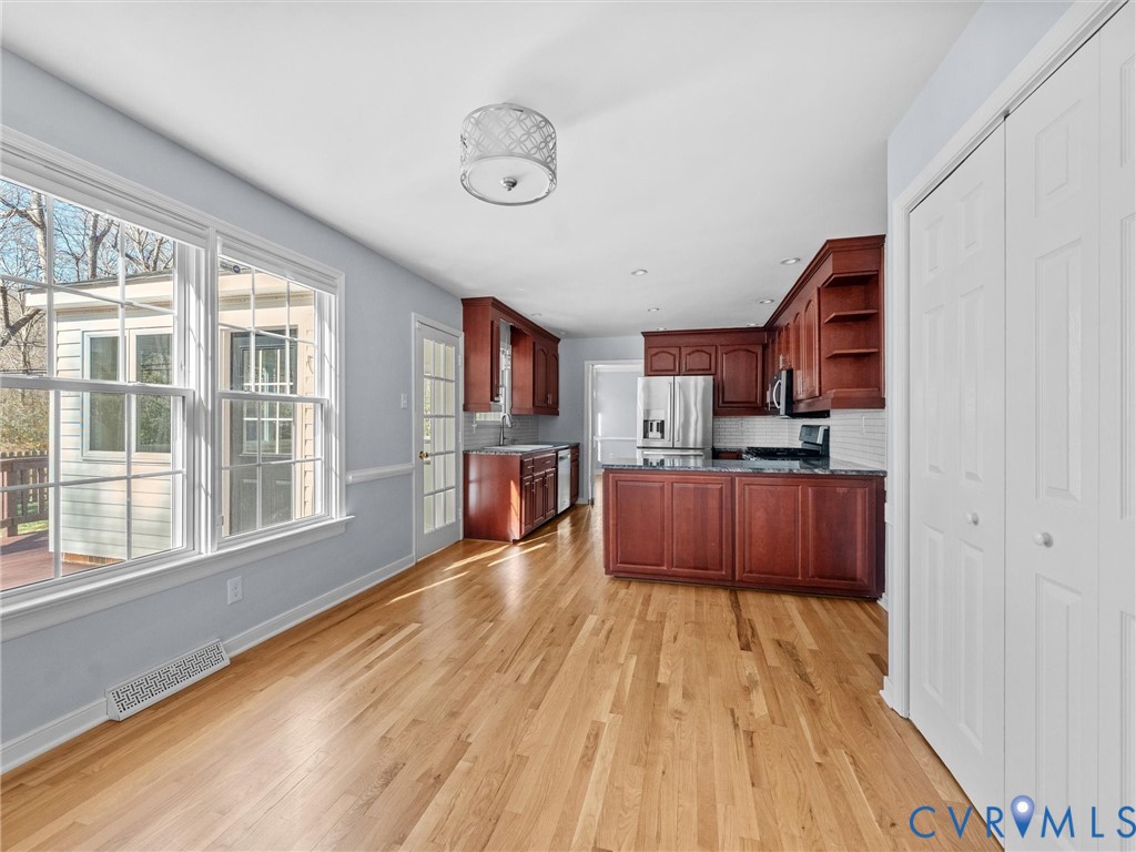 1330 Winslow Road Richmond, VA 23235 - Photo 21 of 46 a large kitchen with cabinets wooden floor and stainless steel appliances