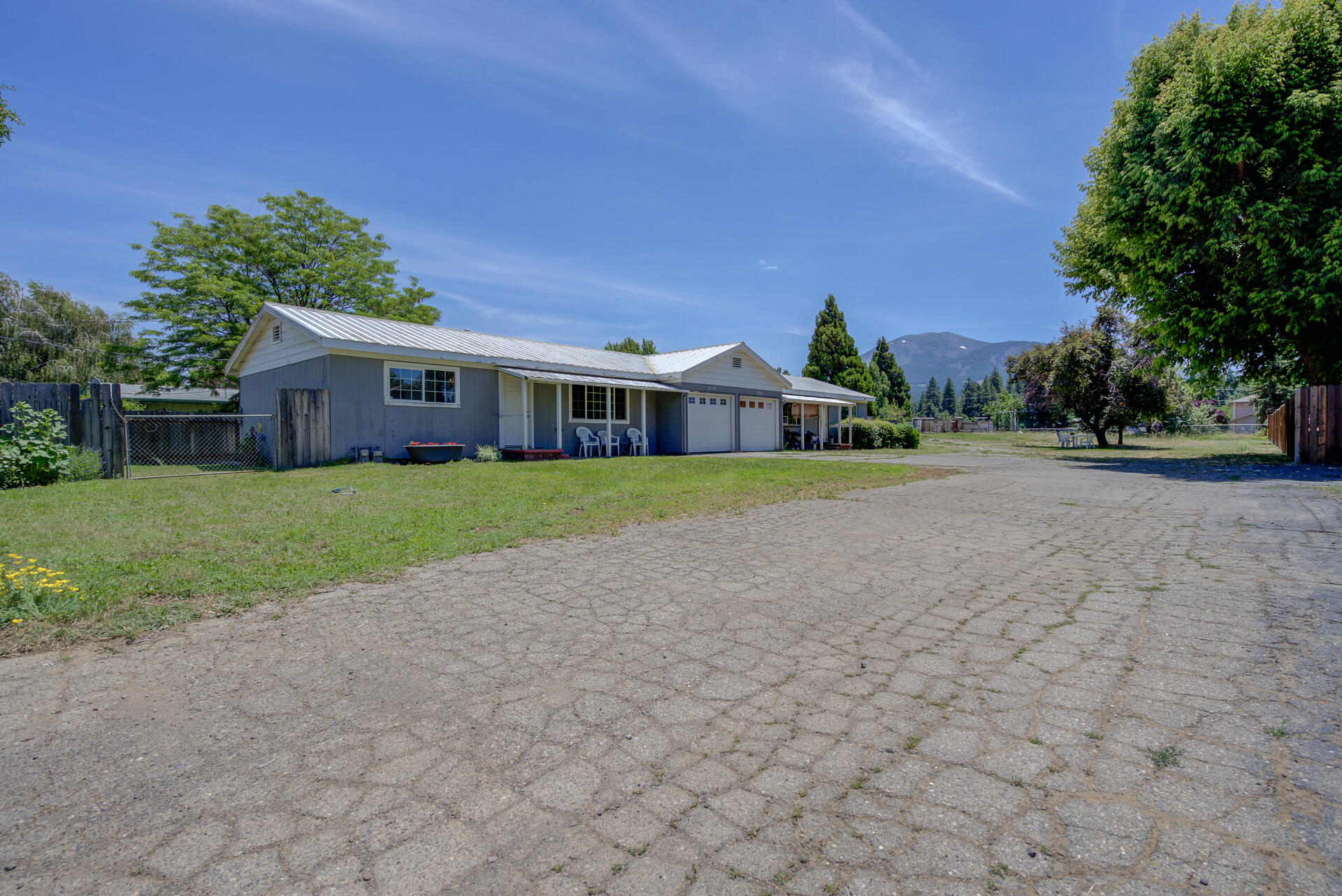 37153-55 Siskiyou Street Burney, CA 96013 - Photo 1 of 32 a view of a house with a yard and potted plants
