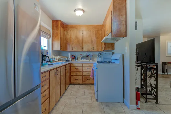 a kitchen with refrigerator and cabinets