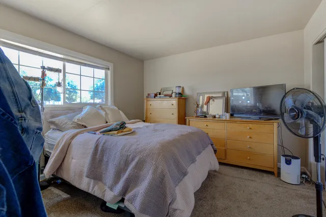 a bed room with a bed and a dresser