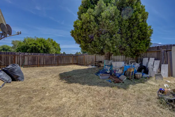 a view of a backyard with a fire pit and furniture
