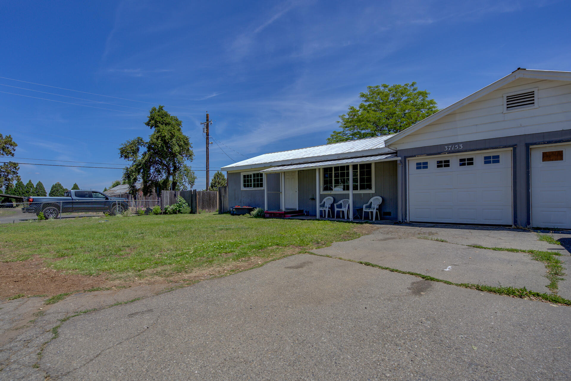37153-55 Siskiyou Street Burney, CA 96013 - Photo 19 of 32 a front view of a house with a yard and potted plants