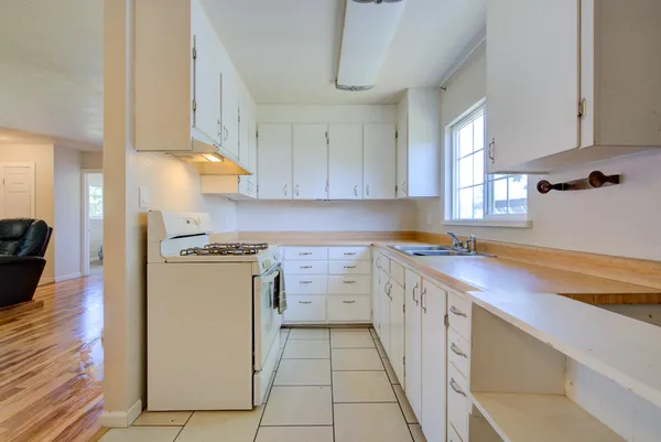a kitchen with a sink stove and cabinets
