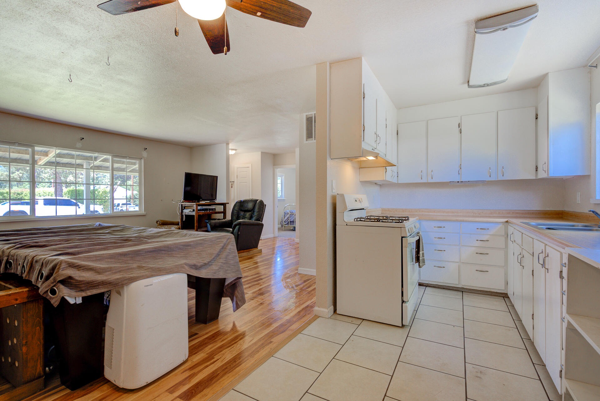 37153-55 Siskiyou Street Burney, CA 96013 - Photo 26 of 32 a kitchen with a sink a stove top oven a counter space and cabinets