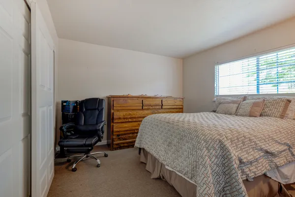a bedroom with a bed and a desk