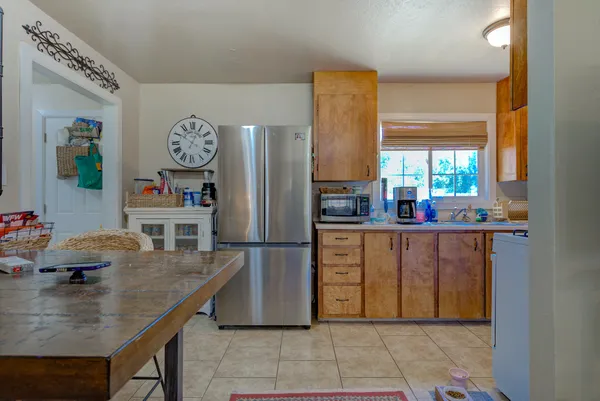 a kitchen with stainless steel appliances granite countertop a refrigerator and a stove top oven