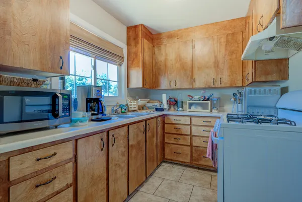 a kitchen with stainless steel appliances a stove sink and cabinets