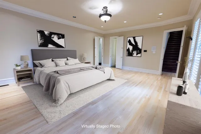 a bedroom with a large bed and a flat screen tv