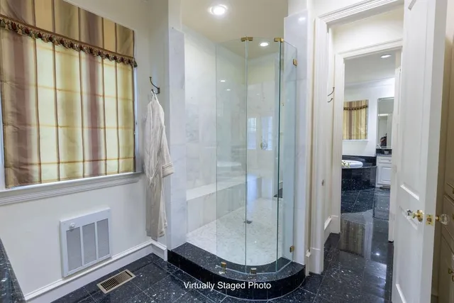 a bathroom with a glass shower door