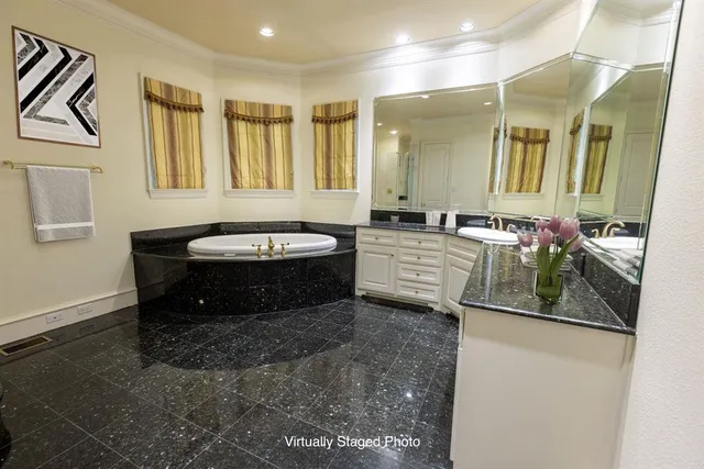 a bathroom with a tub sink and mirror