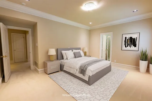 a spacious bedroom with a bed and painting on the wall