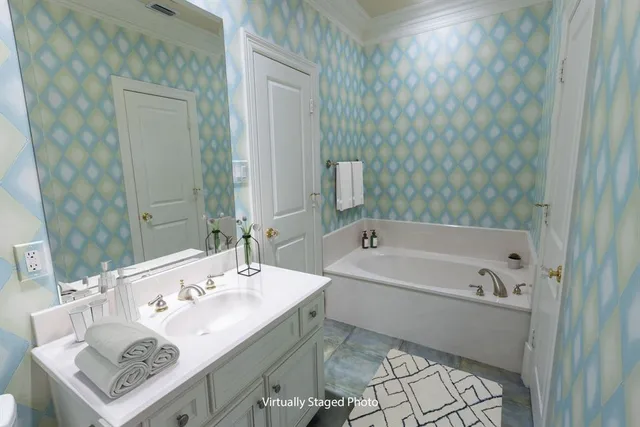 a bathroom with a bathtub a sink and a mirror