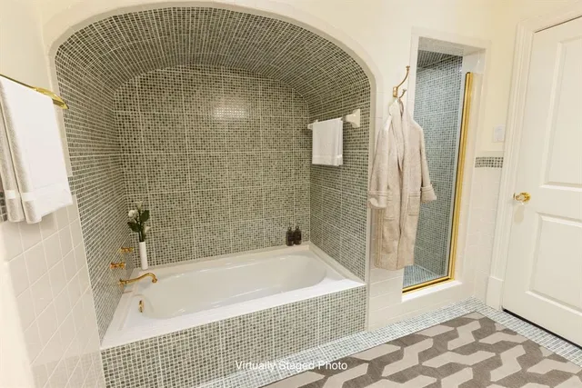 a bathroom with a tub and shower