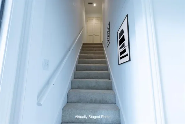 a view of staircase with white walls