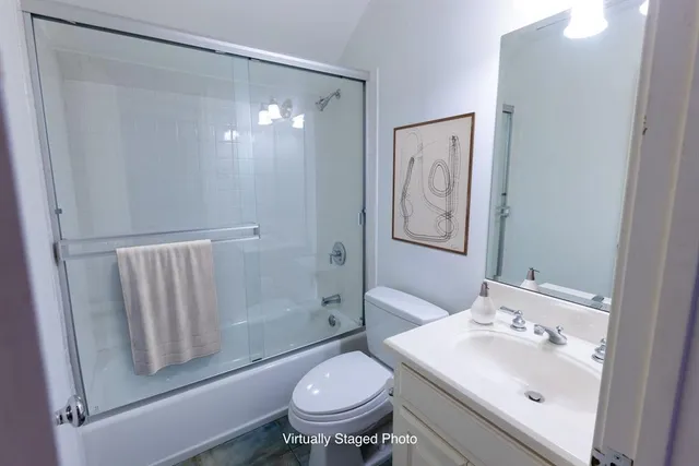 a bathroom with a toilet a sink and a mirror