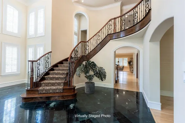 a view of entryway and hall with wooden floor