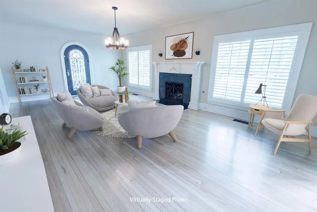 a living room with furniture a window and a fireplace