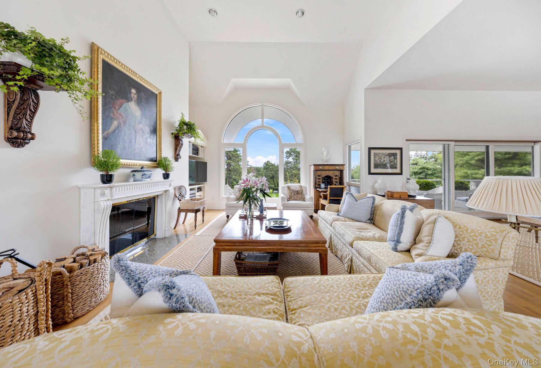 20 Hillside Road Southampton, NY 11968 - Photo 11 of 32 a living room with furniture a fireplace and a large window