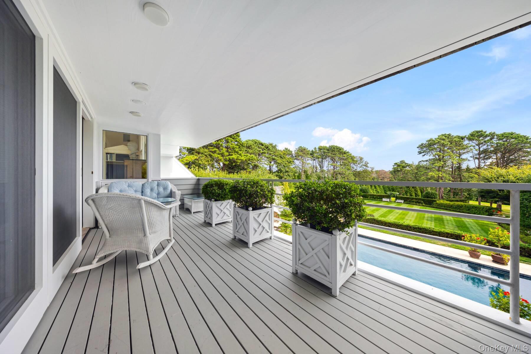20 Hillside Road Southampton, NY 11968 - Photo 14 of 32 a roof deck with table and chairs and wooden floor