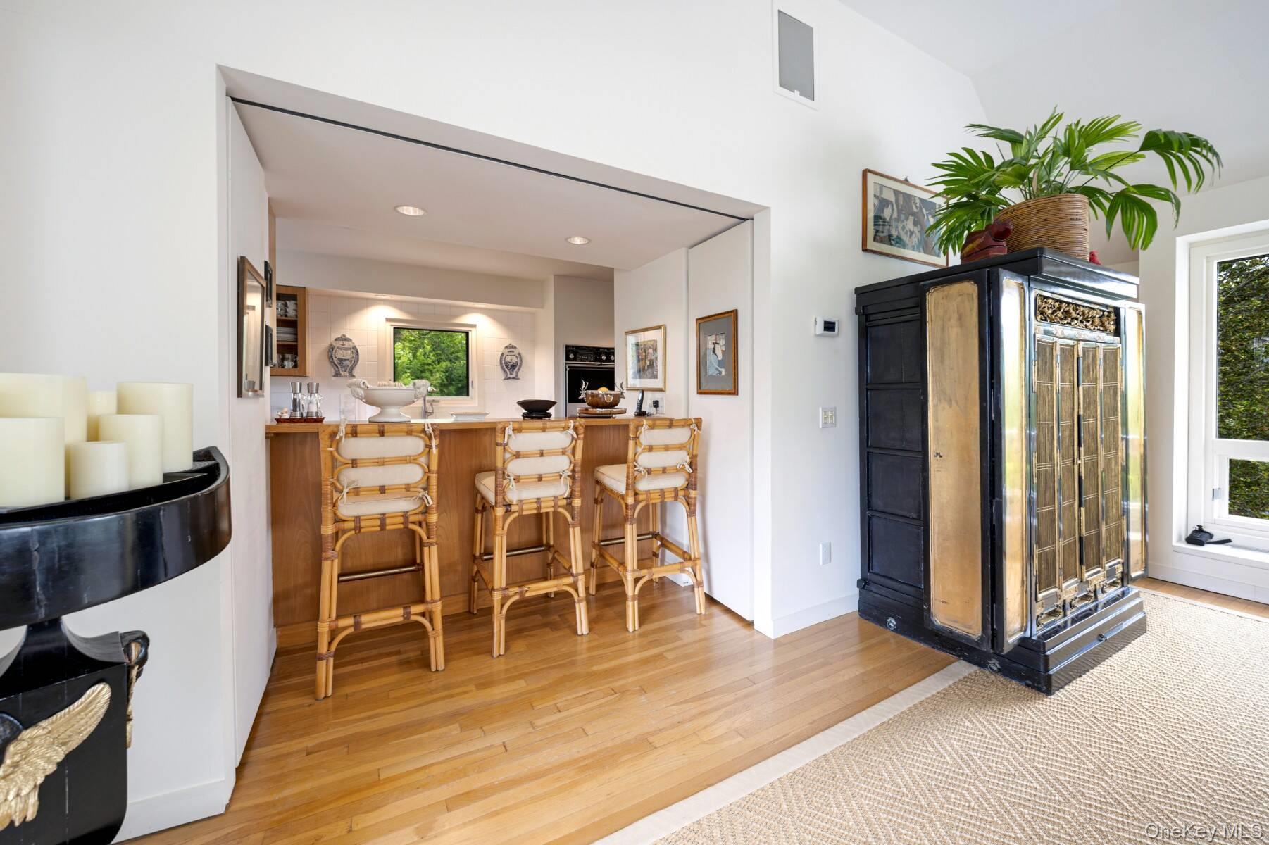 20 Hillside Road Southampton, NY 11968 - Photo 16 of 32 a view of a dining room with furniture and a potted plant