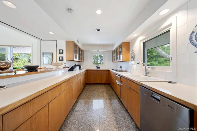a large kitchen with stainless steel appliances lots of counter space and a sink