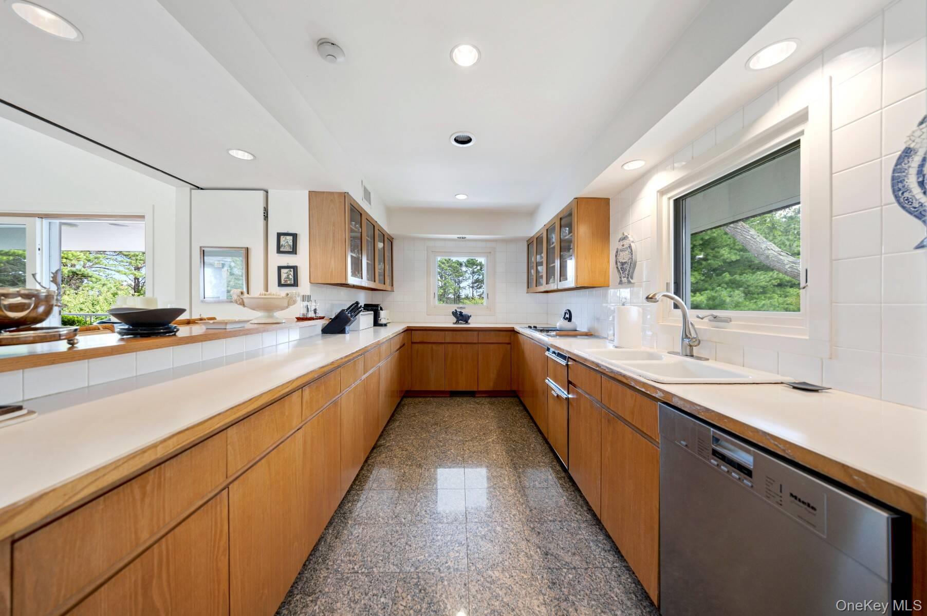 20 Hillside Road Southampton, NY 11968 - Photo 18 of 32 a large kitchen with stainless steel appliances lots of counter space and a sink