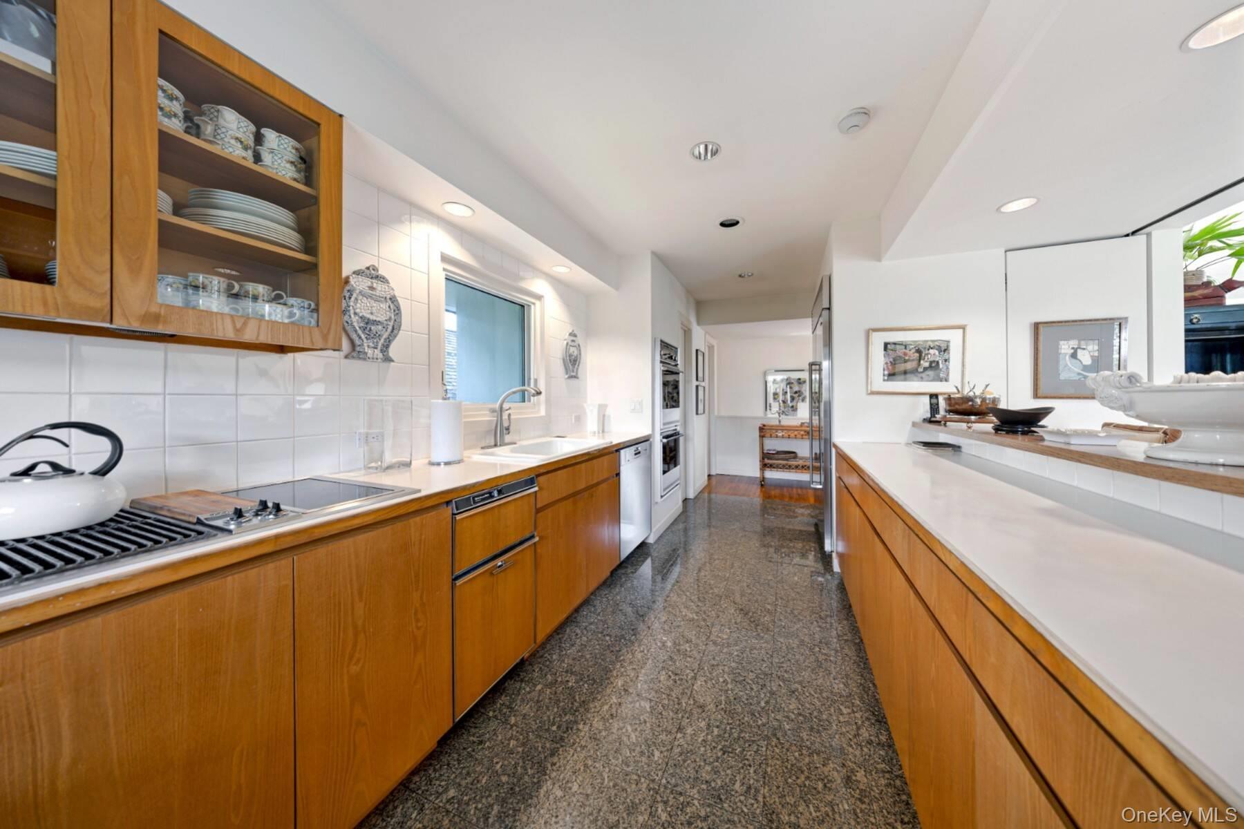 20 Hillside Road Southampton, NY 11968 - Photo 19 of 32 a large kitchen with stainless steel appliances lots of counter space and a sink