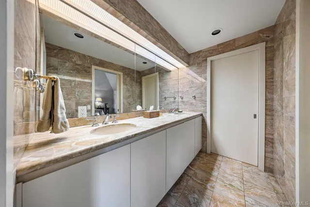 a bathroom with a double vanity sink and a mirror