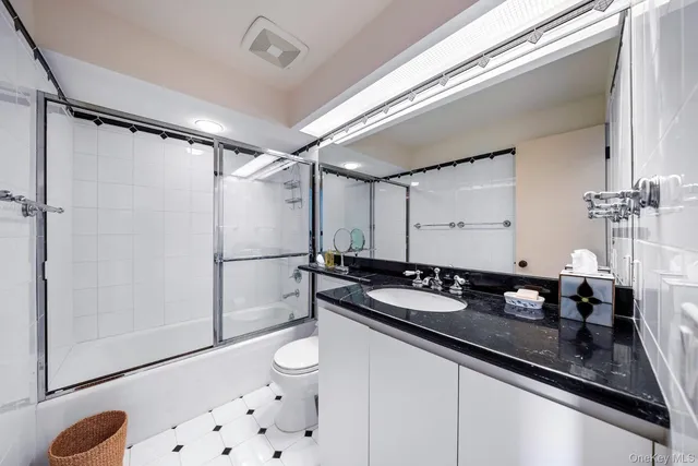 a bathroom with a double vanity sink mirror and shower