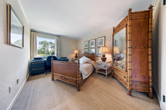 a bedroom with furniture and a window