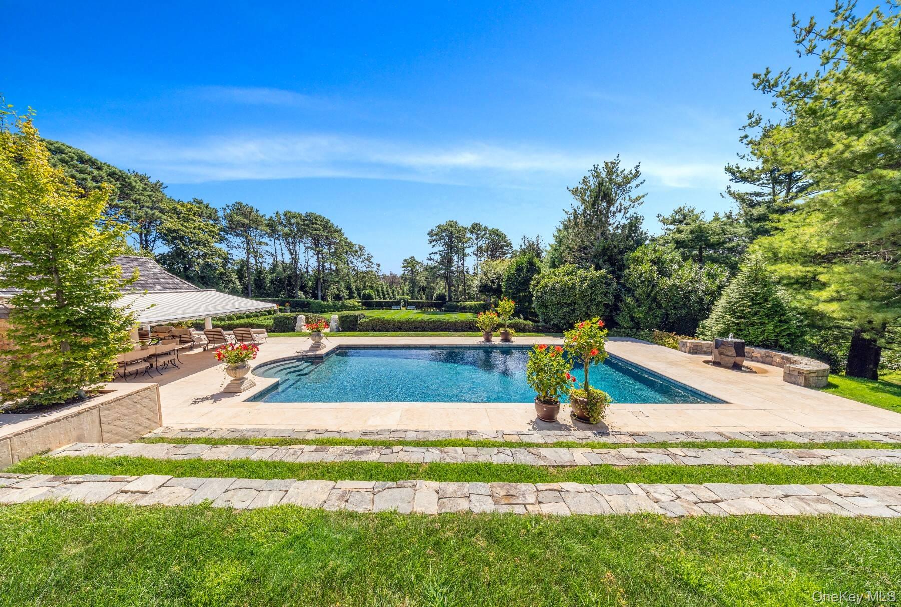 20 Hillside Road Southampton, NY 11968 - Photo 5 of 32 a view of a swimming pool with a yard