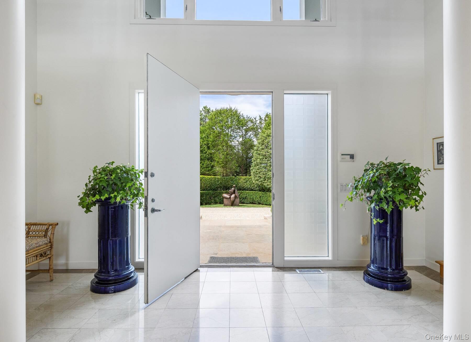 20 Hillside Road Southampton, NY 11968 - Photo 9 of 32 a potted plant sitting in front of a house