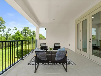 a view of a balcony with chairs and a table