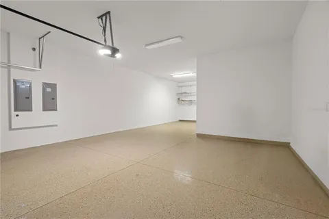 a view of a big room with carpet and windows