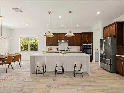 a large kitchen with a table and chairs