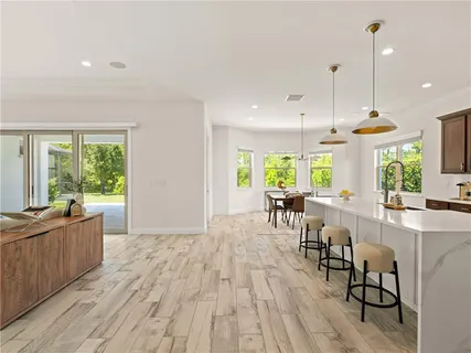 a room with lots of furniture and a wooden floor
