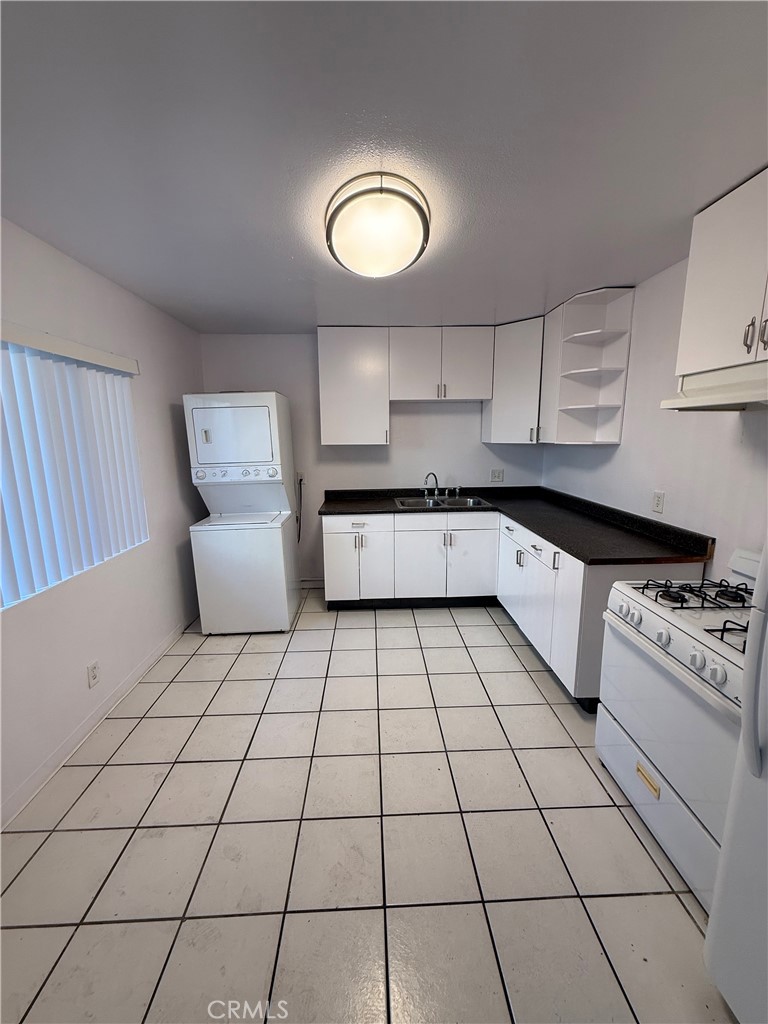 911 East 10th Street Long Beach, CA 90813 - Photo 5 of 19 a kitchen with stainless steel appliances a sink a stove a microwave and cabinets