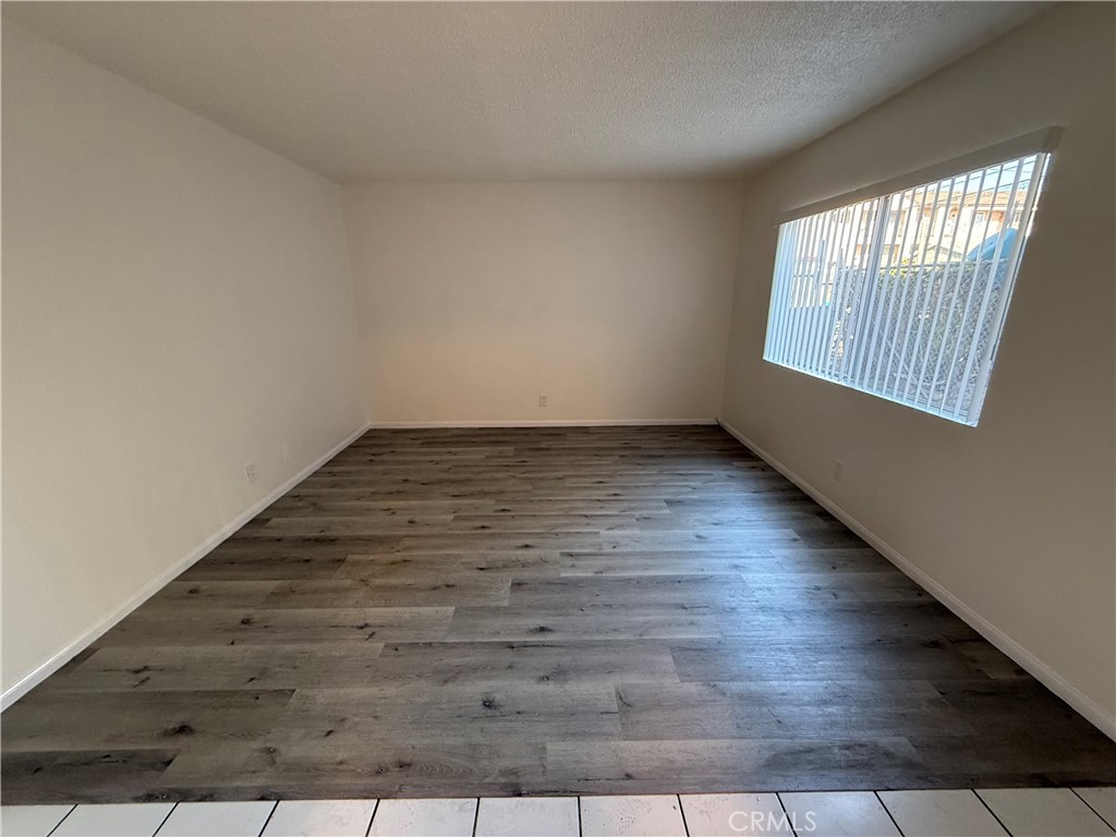 911 East 10th Street Long Beach, CA 90813 - Photo 6 of 19 an empty room with wooden floor and windows