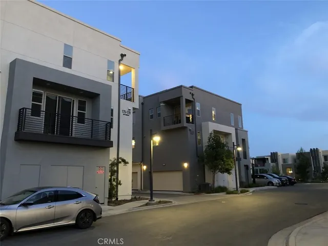 a couple of cars parked in front of a building