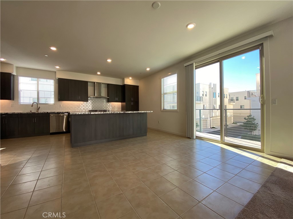 179 Cadence Irvine, CA 92618 - Photo 12 of 41 a living room with stainless steel appliances kitchen island granite countertop a sink and cabinets