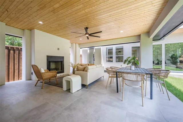 a living room with furniture a fireplace and a table