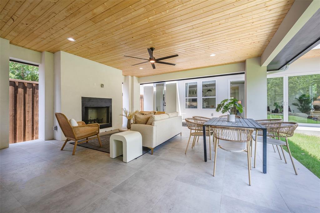 5710 Vanderbilt Avenue Dallas, TX 75206 - Photo 21 of 37 a living room with furniture a fireplace and a table