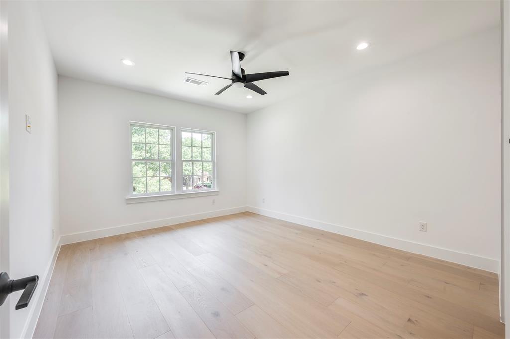 5710 Vanderbilt Avenue Dallas, TX 75206 - Photo 24 of 37 an empty room with wooden floor fan and windows