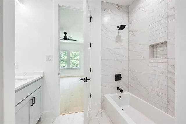 a bathroom with a bathtub and shower