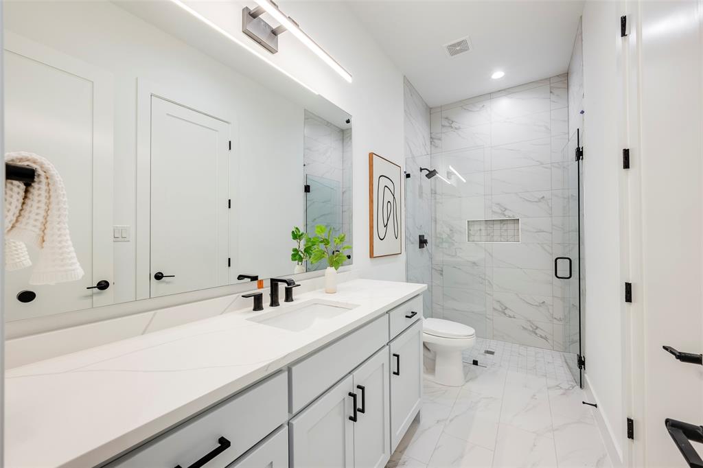 5710 Vanderbilt Avenue Dallas, TX 75206 - Photo 34 of 37 a bathroom with a sink a shower and a mirror