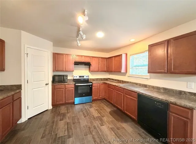 a large kitchen with stainless steel appliances granite countertop a large counter top and sink