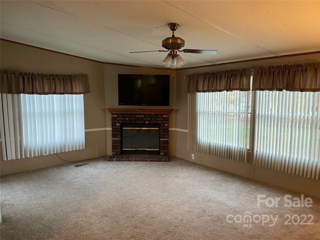 247 Tirzah Church Road, Unit 3 Lancaster, SC 29720 - Photo 15 of 31 a view of an empty room with a fireplace and a window