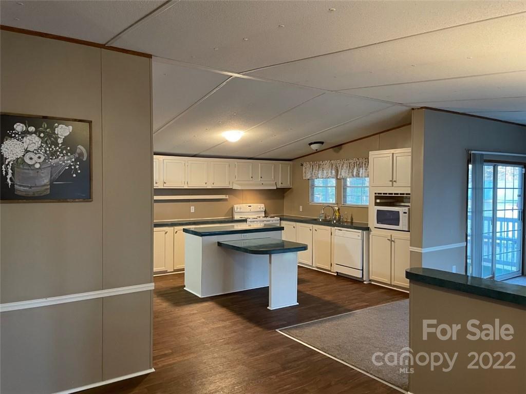 247 Tirzah Church Road, Unit 3 Lancaster, SC 29720 - Photo 17 of 31 a kitchen with stainless steel appliances granite countertop a stove a sink and a microwave