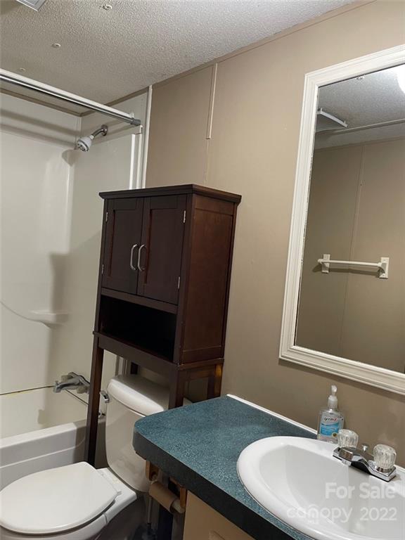 247 Tirzah Church Road, Unit 3 Lancaster, SC 29720 - Photo 28 of 31 a bathroom with a sink a toilet a mirror and shower