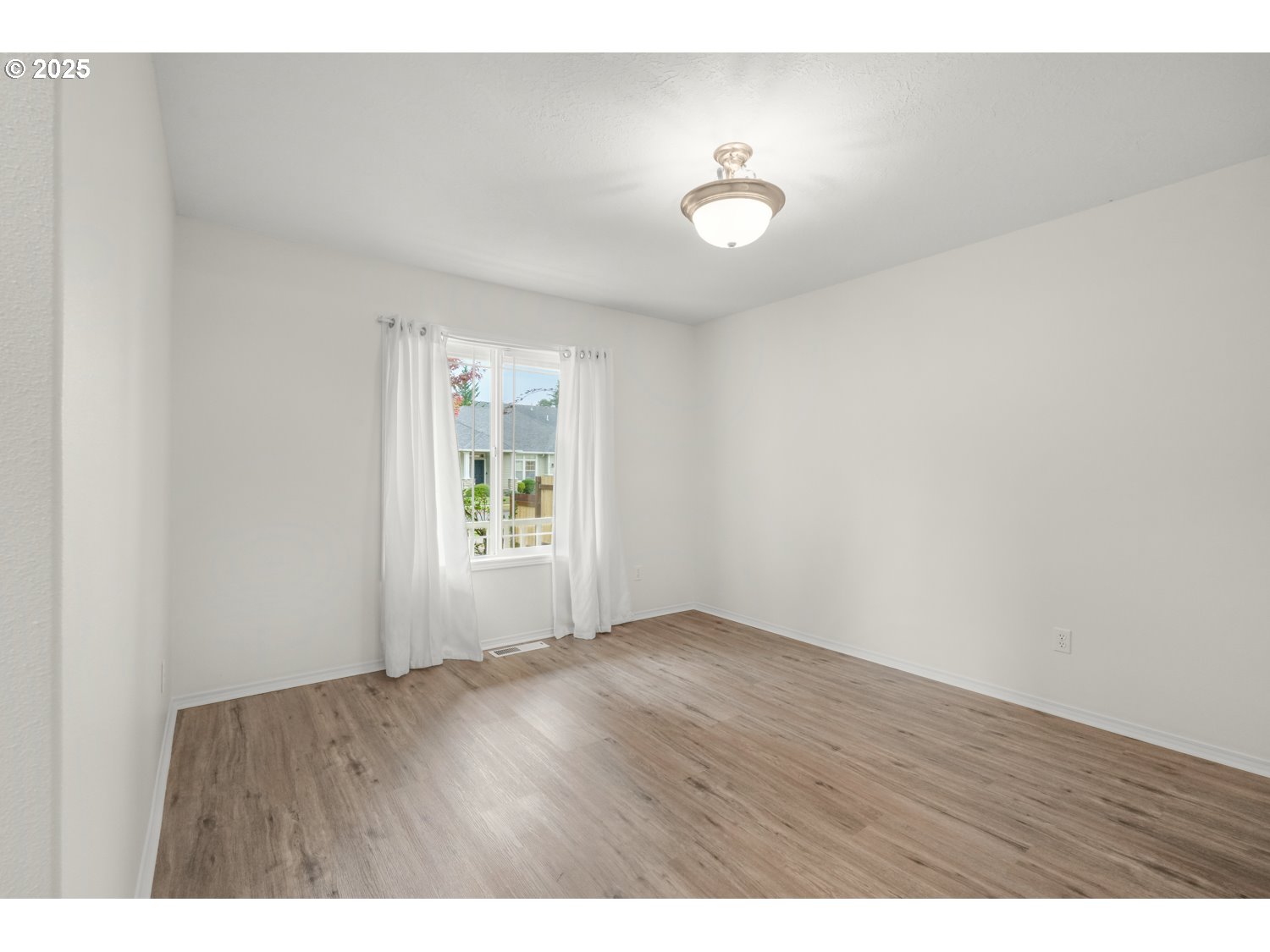 1930 Salmon Run Southwest Albany, OR 97321 - Photo 11 of 26 a view of an empty room with wooden floor and a window